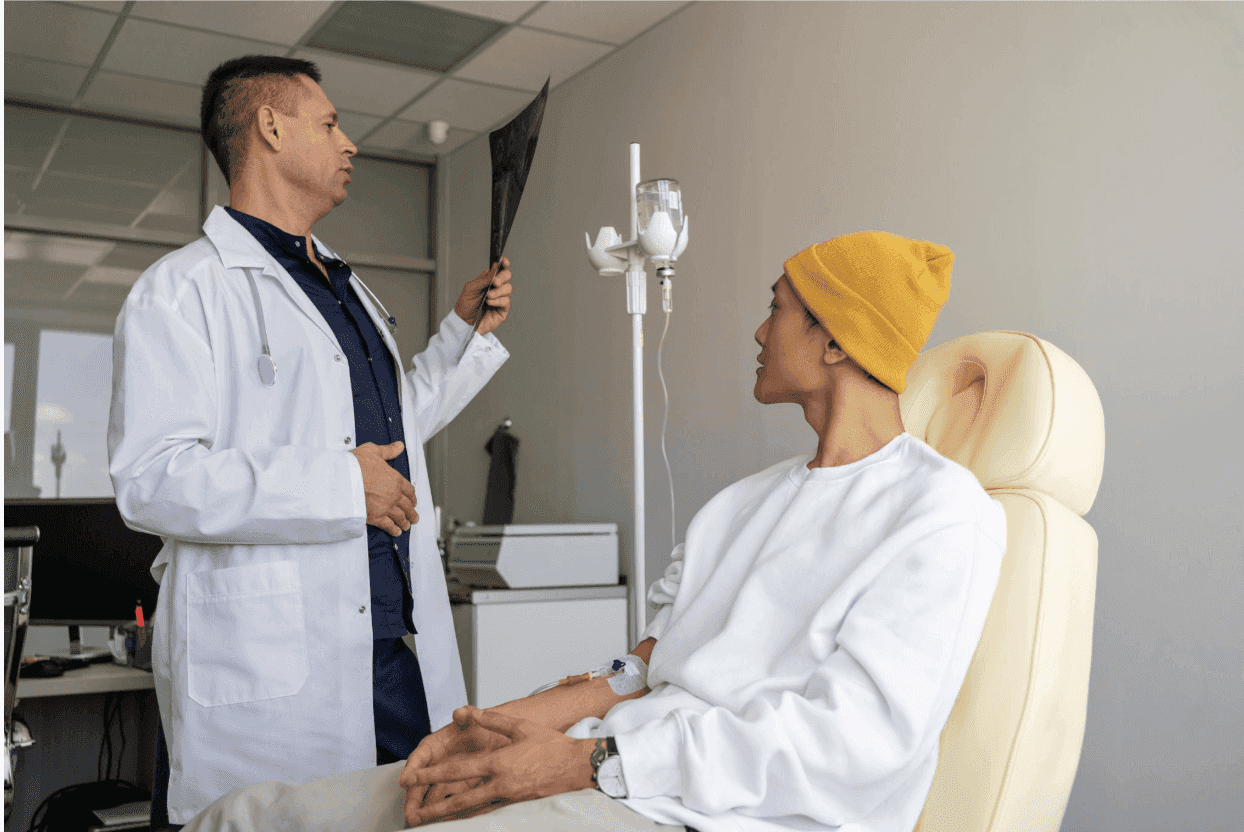 A doctor reviews an X-ray with a patient receiving IV treatment.