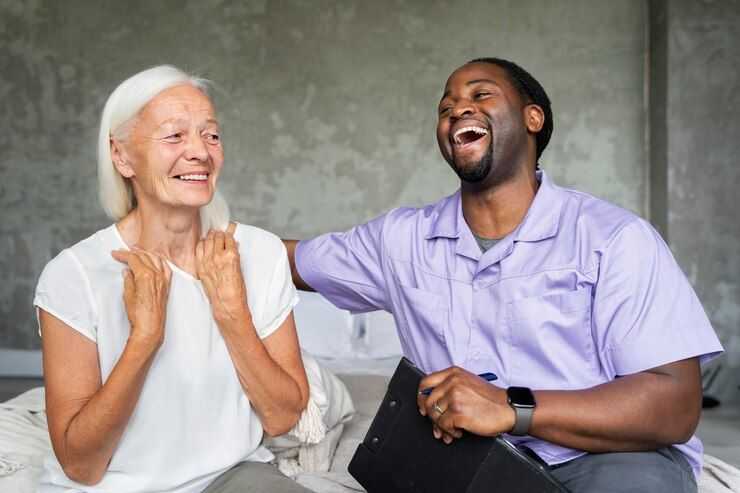 Man laughing with elder woman