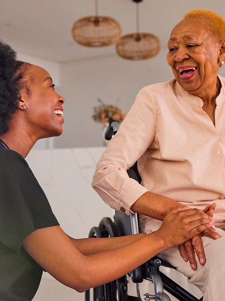 Nurse guiding a senior woman during transitional care at home
