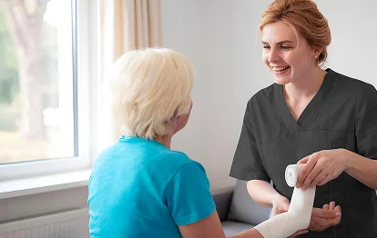 Nurse providing in-home wound care to senior patient