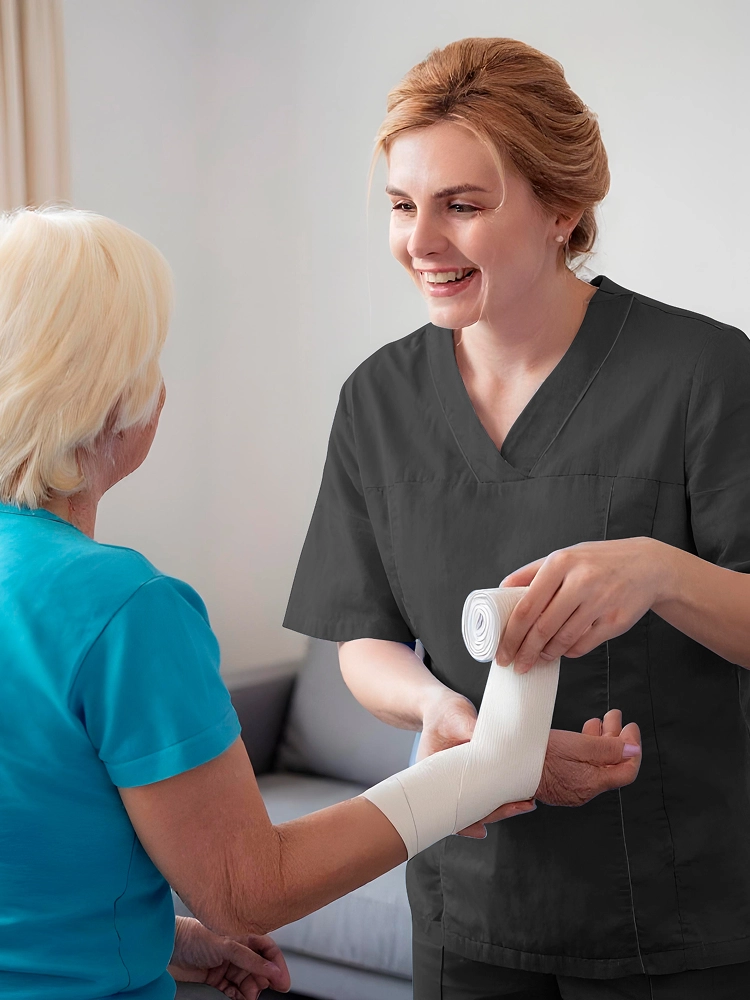 Nurse providing in-home wound care to senior patient