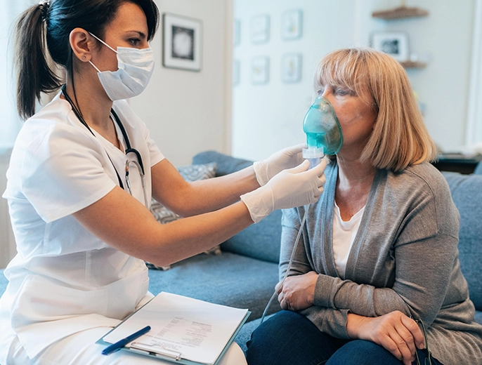 Nurse administering preventive care injection to an older woman at home.